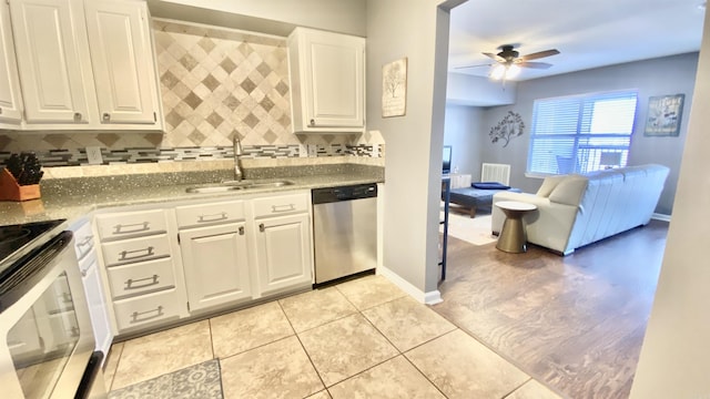 kitchen with appliances with stainless steel finishes, white cabinetry, a sink, and a ceiling fan