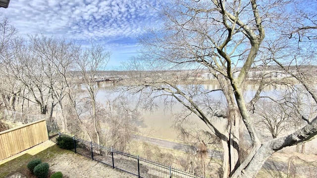 property view of water featuring fence