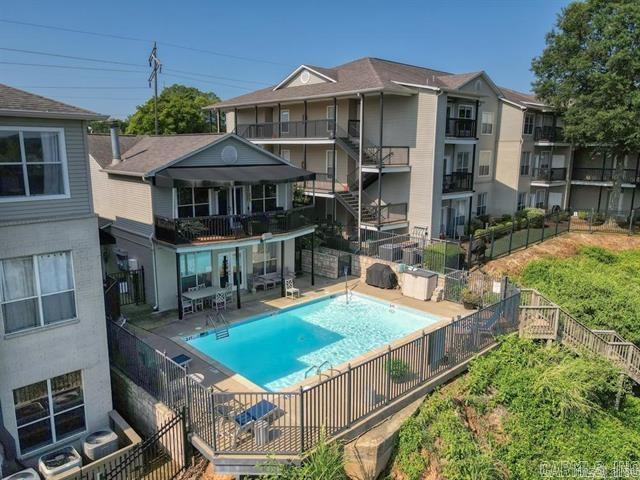 pool with a patio area and fence