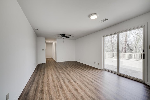 unfurnished living room featuring ceiling fan, wood finished floors, visible vents, and baseboards