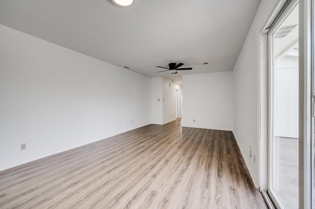 empty room featuring a ceiling fan and wood finished floors