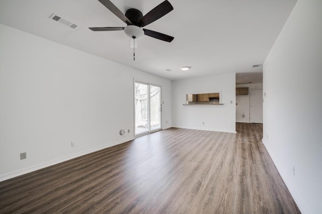 unfurnished living room with visible vents, ceiling fan, baseboards, and wood finished floors