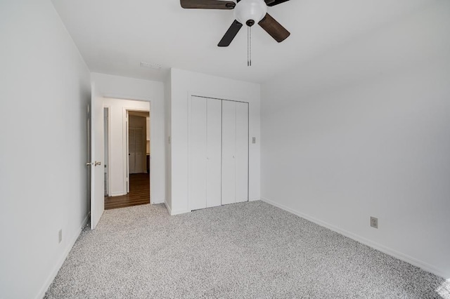 unfurnished bedroom with a ceiling fan, a closet, carpet flooring, and baseboards