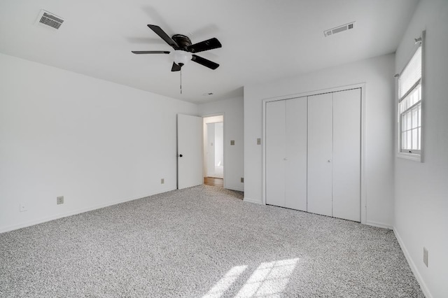 unfurnished bedroom featuring a ceiling fan, a closet, visible vents, and baseboards