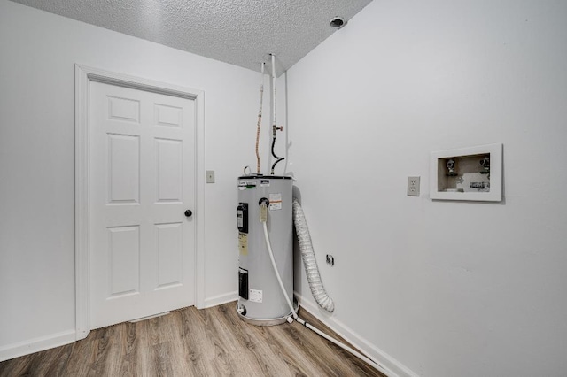 laundry area featuring laundry area, wood finished floors, hookup for a washing machine, a textured ceiling, and water heater