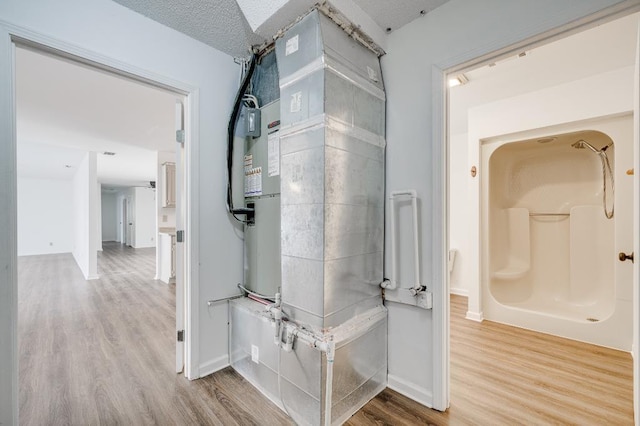 hallway featuring wood finished floors and baseboards