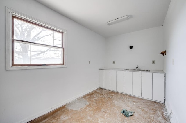 empty room featuring a sink and unfinished concrete floors