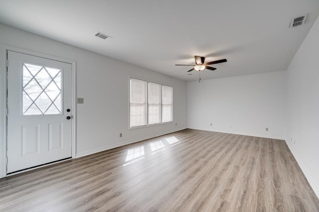 entrance foyer with a wealth of natural light, visible vents, and light wood-style flooring