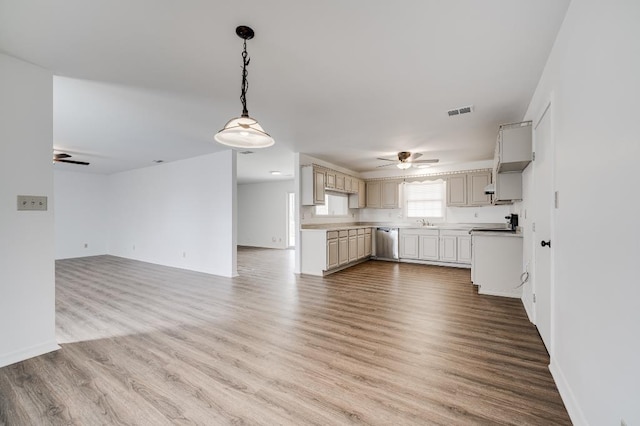 kitchen featuring ceiling fan, wood finished floors, visible vents, open floor plan, and dishwasher