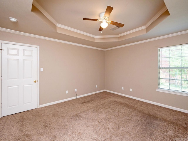 unfurnished room featuring carpet floors, a tray ceiling, and baseboards