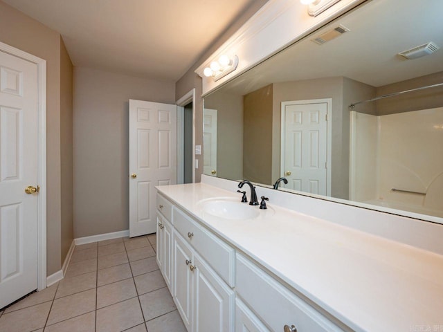 bathroom featuring tile patterned flooring, visible vents, baseboards, and vanity