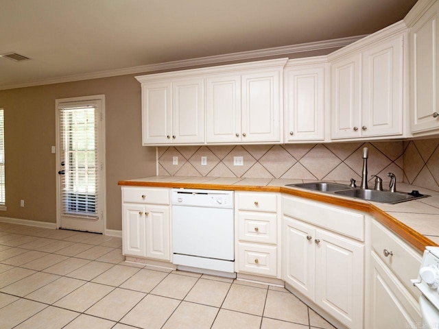 kitchen featuring crown molding, light tile patterned floors, visible vents, white dishwasher, and a sink