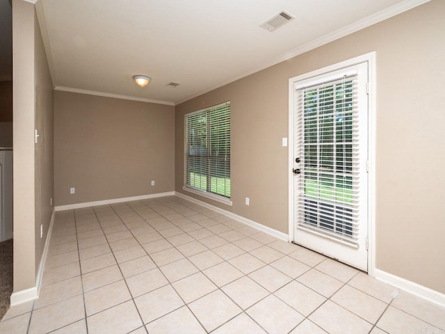 unfurnished room featuring ornamental molding, a healthy amount of sunlight, visible vents, and baseboards