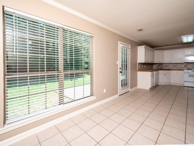 kitchen with white appliances, light tile patterned floors, visible vents, decorative backsplash, and crown molding