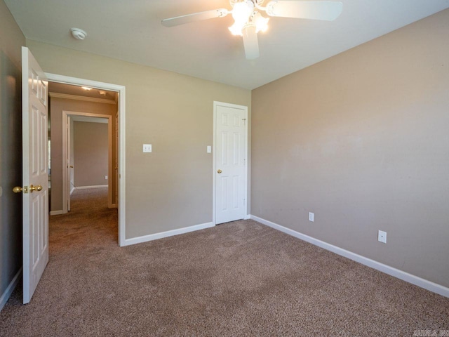 unfurnished bedroom featuring ceiling fan, carpet floors, and baseboards