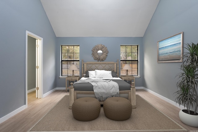 bedroom with high vaulted ceiling, baseboards, and wood finished floors