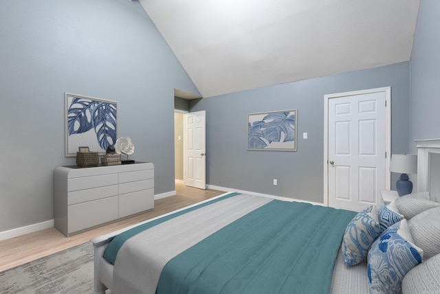 bedroom featuring high vaulted ceiling, baseboards, and wood finished floors