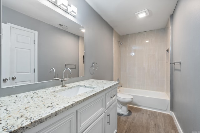 full bath featuring visible vents, toilet, tub / shower combination, vanity, and wood finished floors