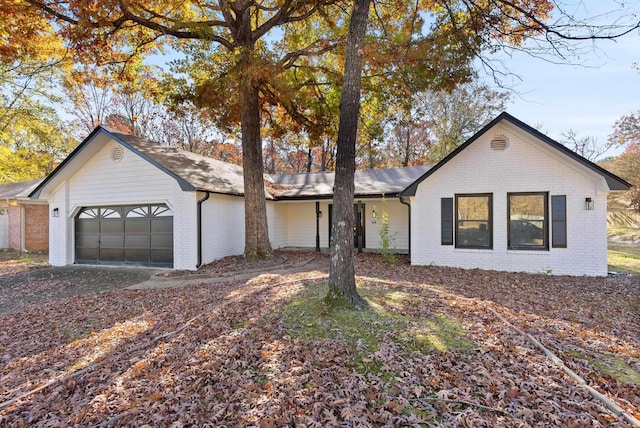 ranch-style home with a garage and brick siding