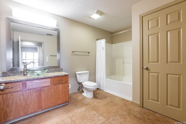 bathroom featuring a textured ceiling, toilet, vanity, tile patterned floors, and shower / tub combo with curtain