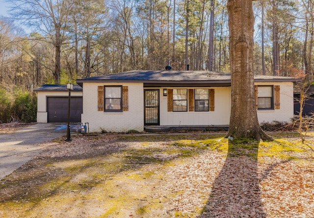 view of front facade featuring a garage, brick siding, and driveway