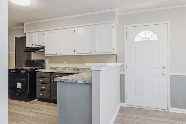 kitchen with crown molding, white cabinets, gas stove, and light wood-style floors