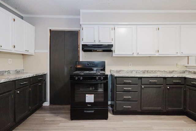 kitchen featuring under cabinet range hood, black gas range, white cabinetry, and ornamental molding