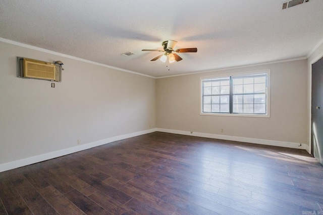 spare room featuring a wall mounted air conditioner, visible vents, a textured ceiling, dark wood finished floors, and crown molding