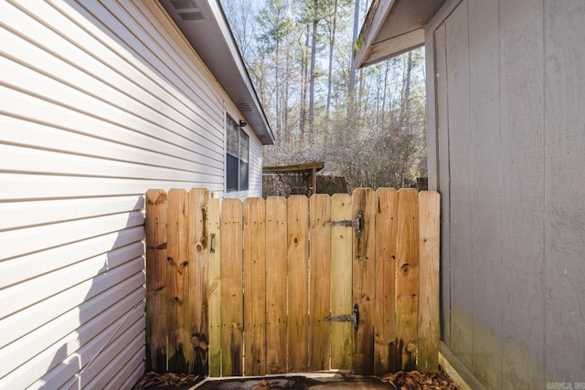 view of side of home with a gate