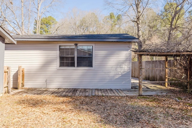 view of side of home featuring fence