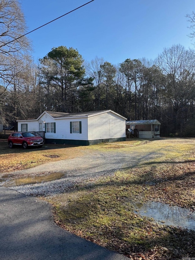 view of side of home featuring driveway