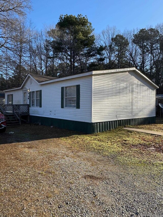 view of side of home with a wooden deck