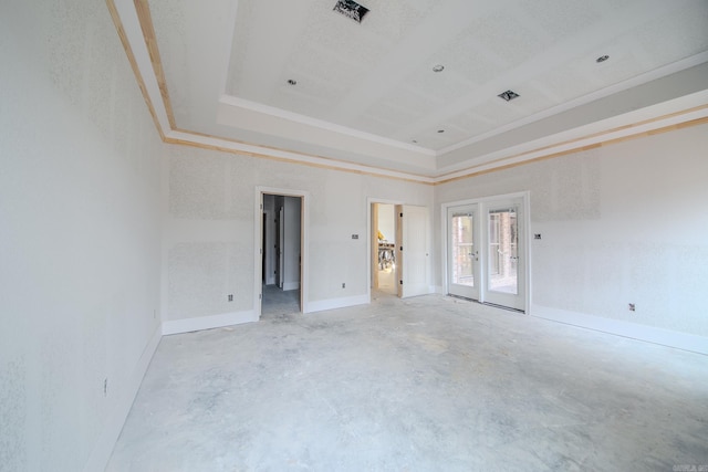 empty room featuring baseboards, visible vents, a tray ceiling, concrete flooring, and french doors