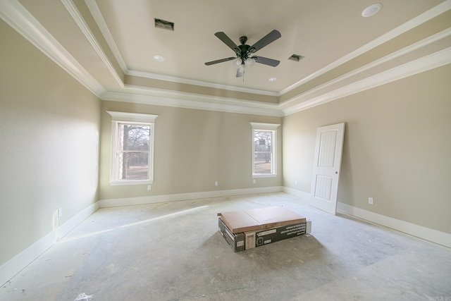 unfurnished room with baseboards, visible vents, a ceiling fan, a tray ceiling, and crown molding