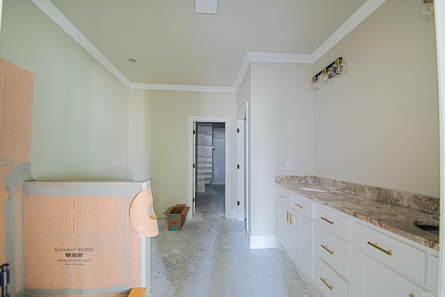 interior space featuring light stone counters, crown molding, white cabinetry, concrete flooring, and baseboards