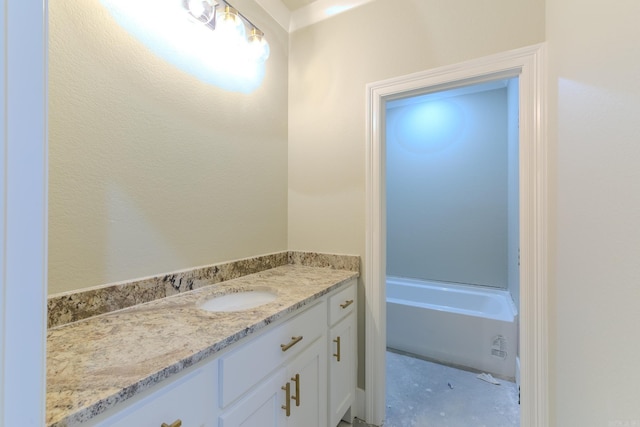 full bath with a bathtub and vanity