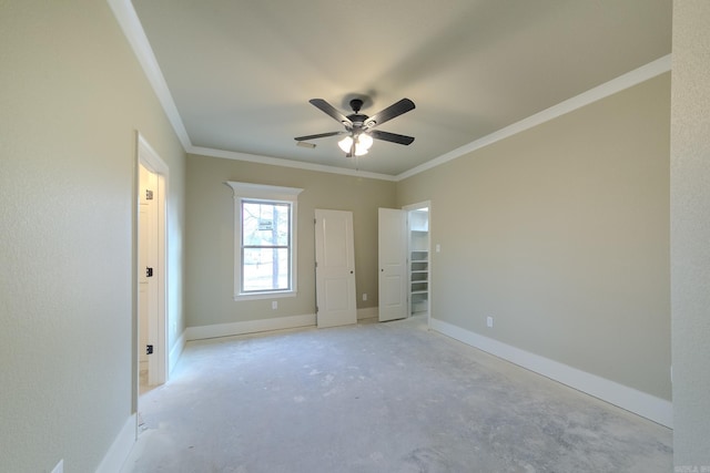 unfurnished bedroom featuring concrete flooring, ornamental molding, and baseboards