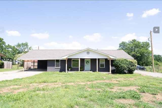 ranch-style house featuring a carport, a front yard, concrete driveway, and fence