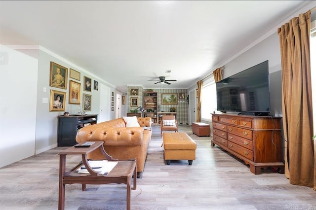 living room with light wood-style floors, crown molding, ceiling fan, and visible vents