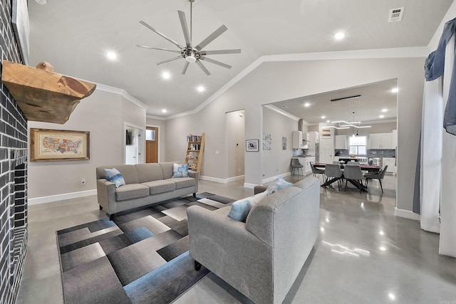 living room with crown molding, vaulted ceiling, finished concrete flooring, and baseboards