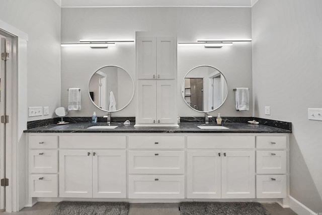 bathroom featuring a sink and double vanity