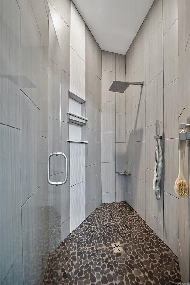 bathroom featuring a stall shower and stone finish floor