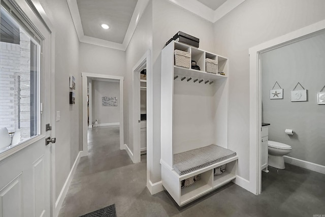 mudroom with finished concrete flooring, crown molding, recessed lighting, and baseboards