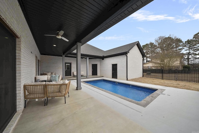 view of swimming pool featuring a fenced in pool, a patio, fence, ceiling fan, and an outdoor living space