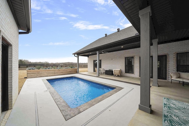 view of pool featuring a patio area and fence