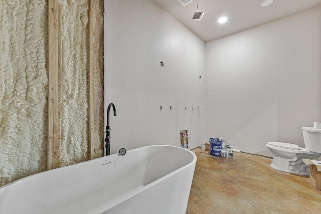 bathroom featuring concrete flooring, a soaking tub, toilet, and recessed lighting