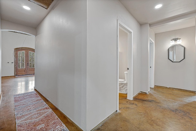 hallway featuring recessed lighting, french doors, and arched walkways