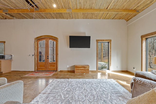 living area with french doors, beamed ceiling, wooden ceiling, and baseboards