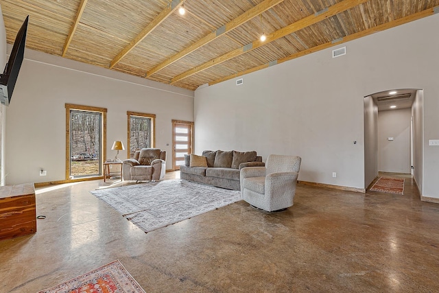 unfurnished living room featuring wooden ceiling, visible vents, high vaulted ceiling, and baseboards