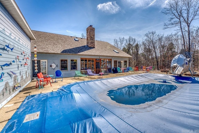 pool with a patio and french doors